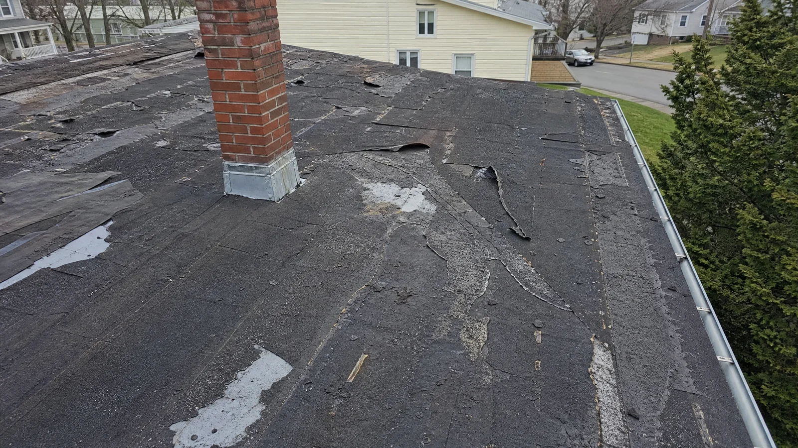 Failing roof with multiple damaged sections in Newington